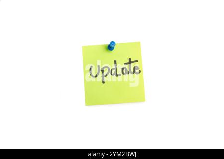 Update word handwritten on a green sticky paper on a white background with copy space Stock Photo