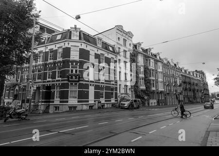 Amsterdam, NL - OCT 14, 2021: Street view and generic architecture in Amsterdam with typical Dutch style buildings. Amsterdam is one of Europe's most Stock Photo