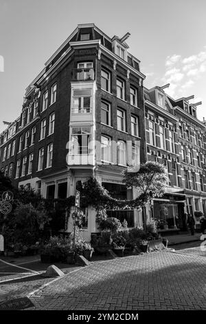 Amsterdam, NL - OCT 14, 2021: Street view and generic architecture in Amsterdam with typical Dutch style buildings. Amsterdam is one of Europe's most Stock Photo