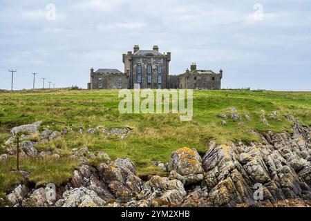 Breachacha Castle (aka Breachacha House), a mid-18th century castle, on the shore of Loch Breachacha on Isle of Coll, Inner Hebrides, Scotland, UK Stock Photo