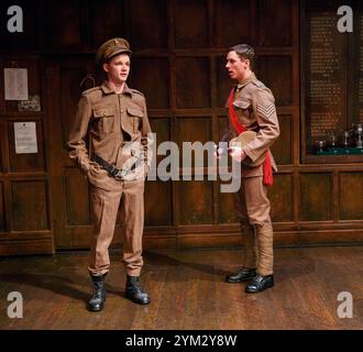 l-r: Rob Callender (Bennett), Rowan Polonski (Fowler) in ANOTHER COUNTRY by Julian Mitchell at the Trafalgar Studios 1, London SW1  03/04/2014  a Chichester Festival Theatre 2013 production  design: Peter McKintosh   lighting: Paul Pyant   director: Jeremy Herrin Stock Photo