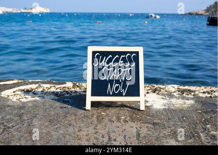 Success Starts Now symbol. Concept words Success Starts Now on black chalk blackboard. Beautiful sea background. Psychological social and Success Star Stock Photo