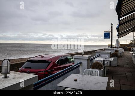 Aldeburgh, Suffolk, 20th November 2024, After a sunny start this Morning storm clouds appeared over the sea causing sleet with a temperature of 4C in Aldeburgh, Suffolk. Feeling seasonal there was a Christmas tree on the beach waiting to be decorated. The forecast is for more cold weather for the next few days. Credit: Keith Larby/Ģ����ý Live News Stock Photo