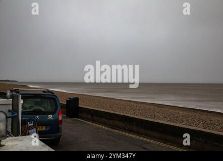 Aldeburgh, Suffolk, 20th November 2024, After a sunny start this Morning storm clouds appeared over the sea causing sleet with a temperature of 4C in Aldeburgh, Suffolk. Feeling seasonal there was a Christmas tree on the beach waiting to be decorated. The forecast is for more cold weather for the next few days. Credit: Keith Larby/Ģ����ý Live News Stock Photo