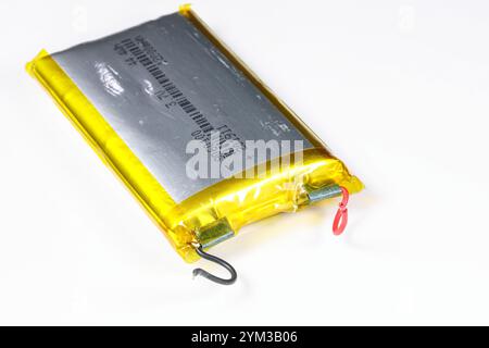 damaged swollen Lithium polymer, Li-ion batteries for mobile device isolated on white background. Stock Photo