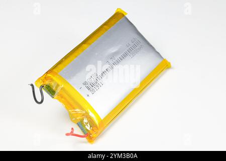 damaged swollen Lithium polymer, Li-ion batteries for mobile device isolated on white background. Stock Photo