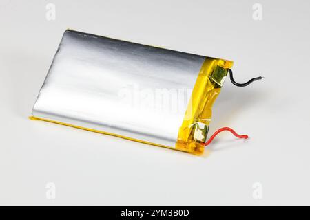 damaged swollen Lithium polymer, Li-ion batteries for mobile device isolated on white background. Stock Photo