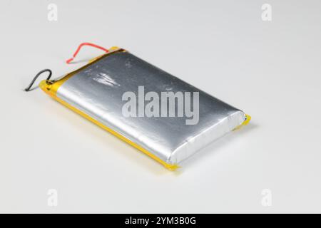 damaged swollen Lithium polymer, Li-ion batteries for mobile device isolated on white background. Stock Photo