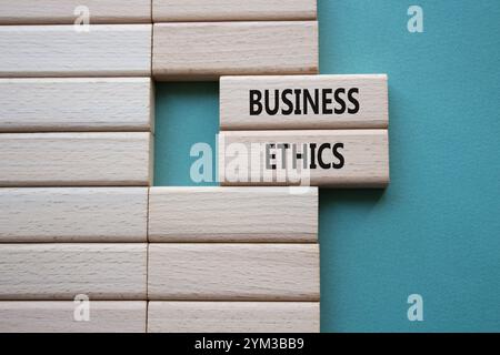 Business ethics symbol. Concept word Business ethics on wooden blocks. Beautiful grey green background. Business and Business ethics concept. Copy spa Stock Photo