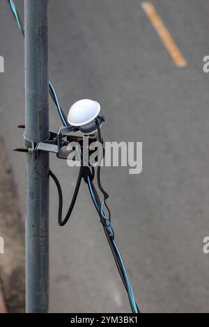 Photoelectric sensor switch Installed on an public electric pole, Automatic turn on and off by Sun light. use for electric lamps. Stock Photo