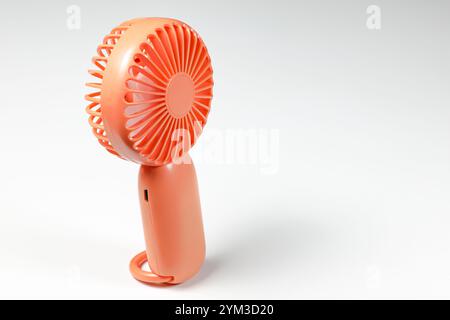 Small plastic Portable fan side view, isolated on white background. Stock Photo