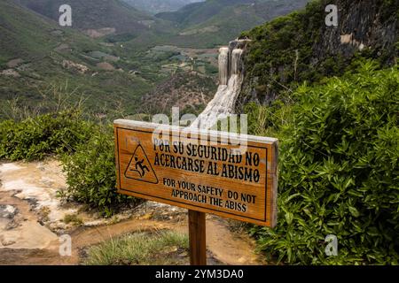 Petrified waterfall of Hierve el Agua, Oaxaca Mexico, with danger sign in front of it. Stock Photo