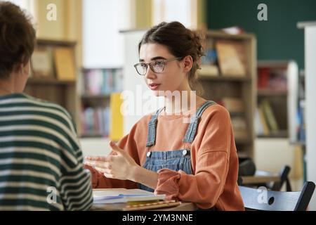 Engaging in Discussion at Library Study Session Stock Photo