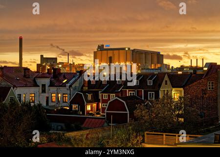 The AAK (AarhusKarlshamn) production plant at sunset among residential buldings in central Karlshamn. Stock Photo