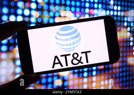 In this photo illustration an AT&T logo seen displayed on smart phone ...