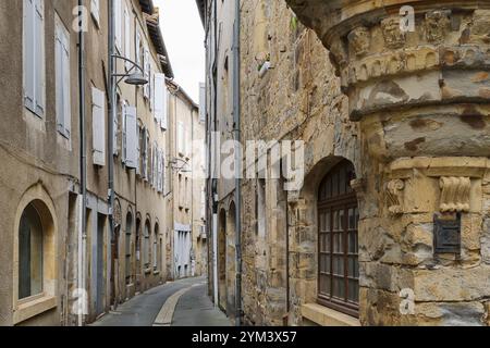 Old narrow medieval street in Saint-Céré Lot Occitanie in Southern France with dilapidated houses made of plastered natural stone Stock Photo