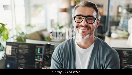 Man, programmer and glasses in agency for portrait, web development or software engineering on screen. Mature coder, happy or tech in office for Stock Photo