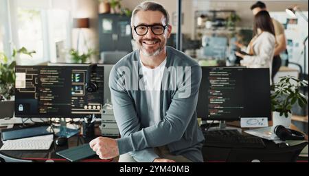 Happy man, coder and glasses in office for portrait, website development and software engineering on screen. Mature programmer, smile and computer in Stock Photo