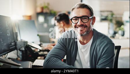 Happy man, programmer and glasses in office for portrait, website development or software engineering at tech. Mature IT guy, smile or pride in agency Stock Photo