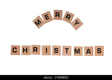 "Merry Christmas" on small wooden tiles against white background Stock Photo