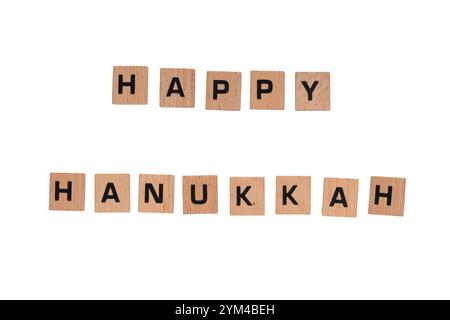 "Happy Hanukkah" on small wooden tiles against white background Stock Photo
