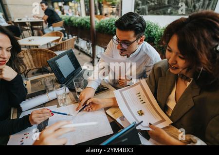 Multicultural team having a coffee meeting discussing project ideas Stock Photo