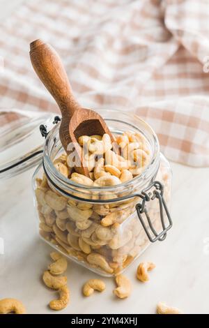 Roasted cashew nuts in jar on a kitchen table. Stock Photo