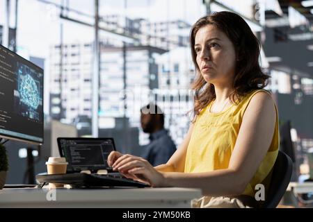 Programmer developing artificial intelligence machine learning APIs solving complex problems. Woman training AI predictive models capable of handling language processing tasks Stock Photo