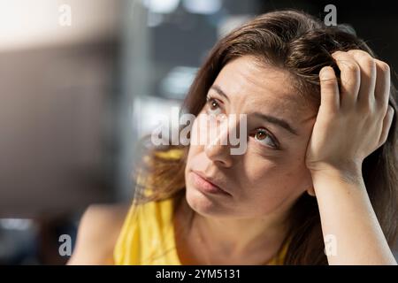 Pensive programmer thinking how to design and develop software applications. Contemplative IT professional brainstorming ways of implementing and maintaining company systems, close up Stock Photo