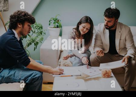 Students collaborating on a creative project in a modern room Stock Photo