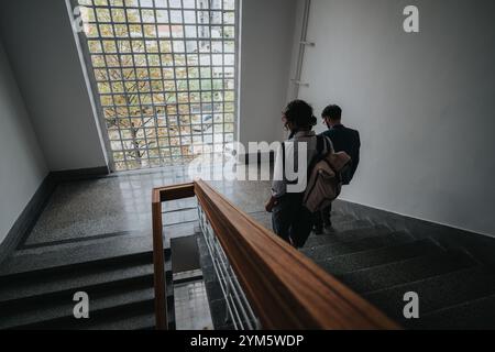 Two students walking down staircase in school building Stock Photo