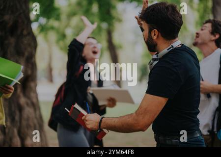 Multicultural students collaborating on a group project outdoors Stock Photo