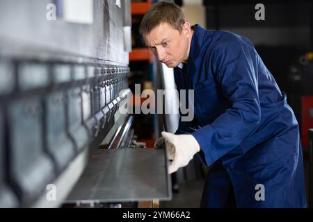 Metal sheet bending machine shaping metal Stock Photo - Alamy