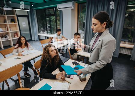 Teacher engaging with students in a modern classroom setting Stock Photo
