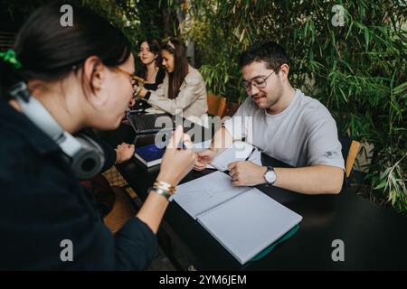 High school students collaborating on assignments in a cozy coffee shop setting Stock Photo