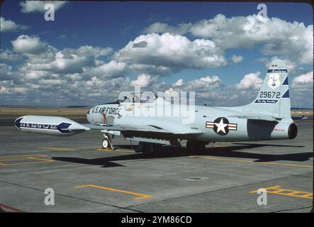 T-33A beauty shot. Clean lines of Lockheed T-Bird stand out, on the Montana ANG ramp at Great Falls IAP on a typical sunny day.  Tip tanks were a necessity due to the reduction in fuselage tank capacity from the P-80 to fit the rear cockpit. Note speed brakes and flaps beneath fuselage and wings. Stock Photo