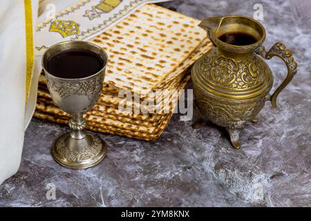 Matzah is stacked decorative wine cup an this setting reflects cultural religious traditions during Passover during Jewish Holiday Stock Photo