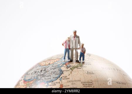 Globes and miniature dolls Stock Photo