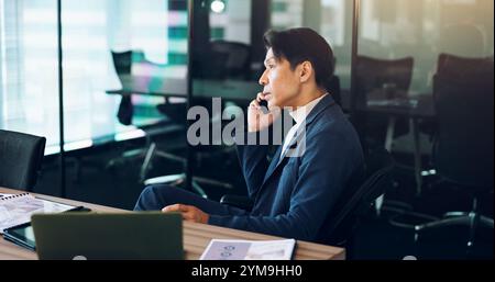 Man, profile or phone call in office for business, serious negotiation or problem solving. Mature broker, discussion or tech in Japan agency for Stock Photo
