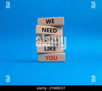 Hiring symbol. Wooden blocks with words We need People like You. Beautiful blue background. Business and Hiring concept. Copy space. Stock Photo
