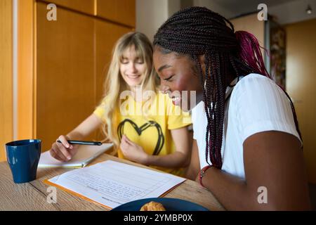 Multiethnic students collaborating on project, sharing knowledge and achieving success together Stock Photo