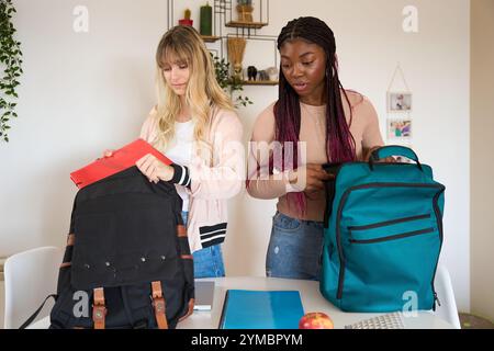 Multiethnic students preparing backpacks for school or university Stock Photo