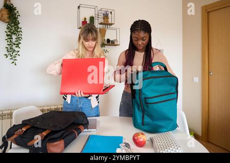 Multiethnic students preparing backpacks at home Stock Photo