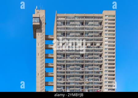 A Brutalist style tower block, Trellick Tower, on the Cheltenham Estate in Kensal Town, London, UK against a cloudless sky Stock Photo