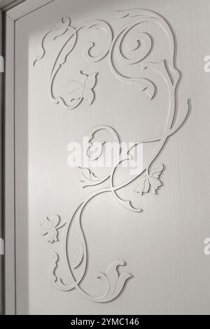 Texture of a flower-shaped inlay, on the wooden door of a white cabinet Stock Photo