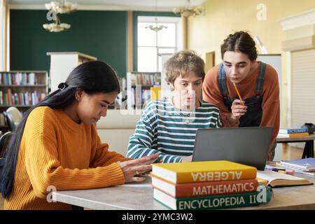 Collaborating Students Studying Together in Library Stock Photo