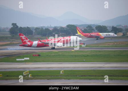 HANOI, VIETNAM - JANUARY 12, 2016: Thai AirAsia Airbus A320 aircraft lands at Noi Bai Airport. Hanoi, Vietnam Stock Photo