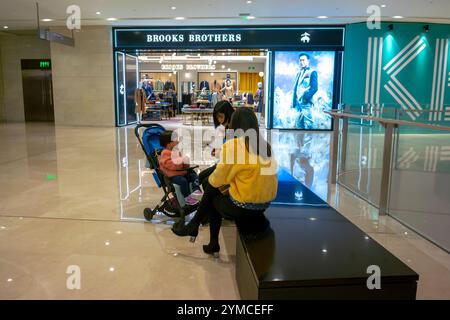 Chengdu, China, Sichuan, Chinese Tourists Shopping, Women sitting on Bench talking, Luxury Store, inside, "Brooks Brothers » Store, middle class asia, Stock Photo