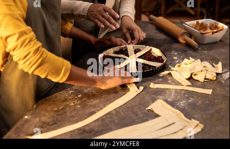 Preparing pie, grandmother and asian female teenager, at home Stock Photo