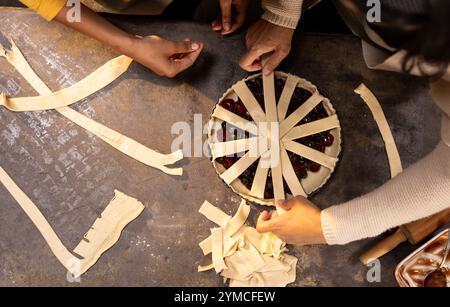 Grandma and asian female teenager preparing homemade pie together for celebration Stock Photo